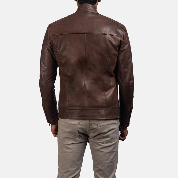 Brown leather jacket worn by a person on a white background