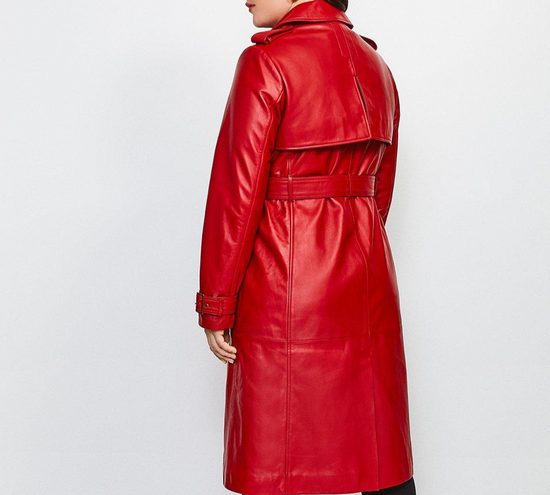 Red leather trench coat worn by a person on a white background