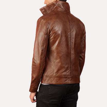 Brown leather jacket worn by a person on a plain background