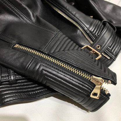 Women leather jacket black close-up double zipper and quilted leather detail gold hardware
