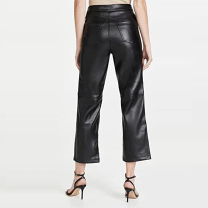 Black leather pants worn by a person on a white background