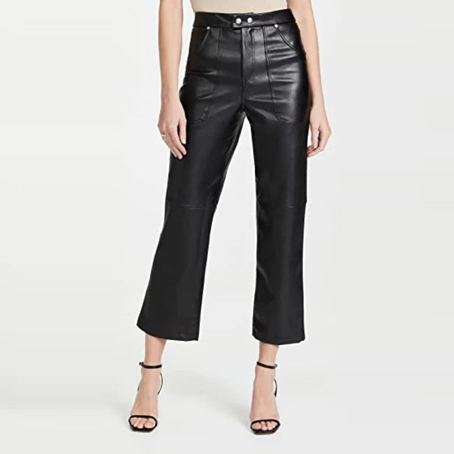 Person wearing black leather pants on a white background