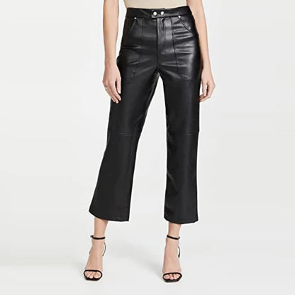 Person wearing black leather pants on a white background