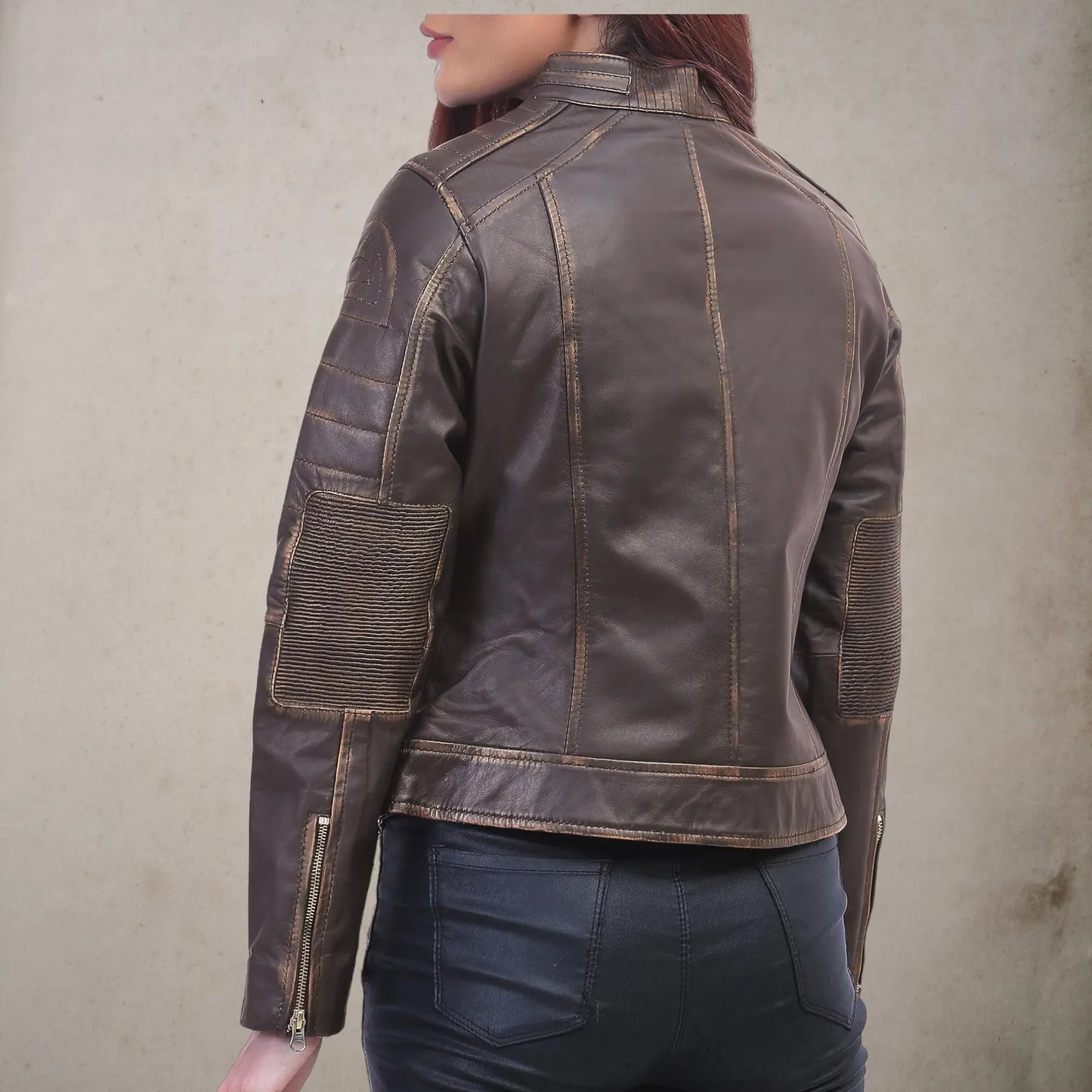 Women leather jacket back view showing quilted sleeve panels and double stitching