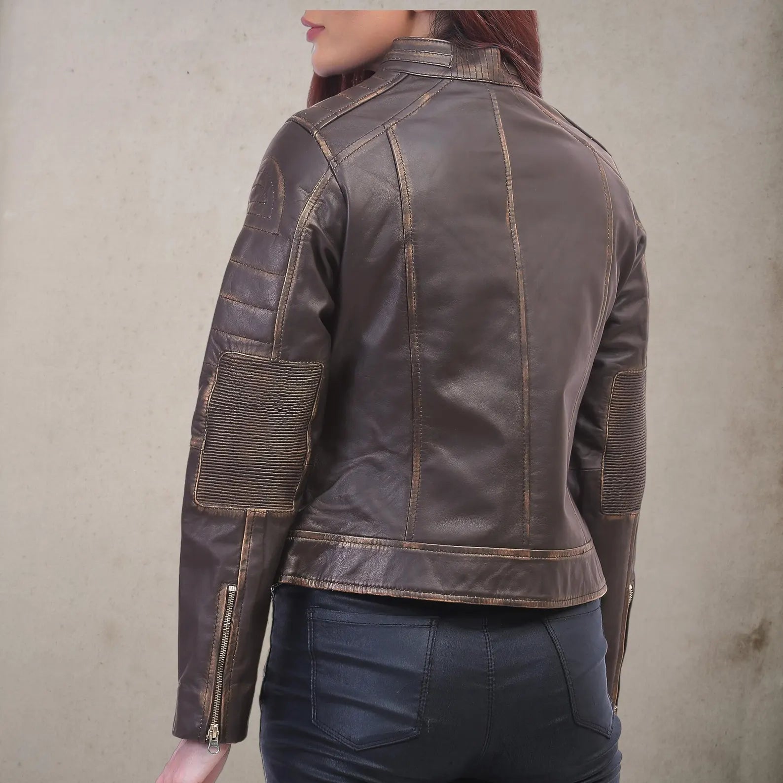 Women leather jacket back view showing quilted sleeve panels and double stitching