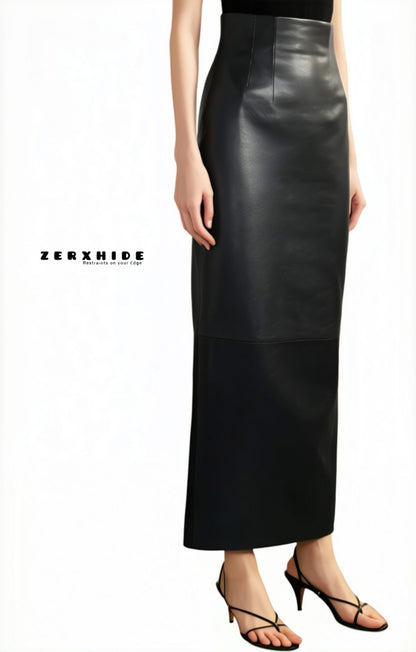 Woman wearing ZERXHIDE black leather skirt — full length maxi with side slit, styled with sleeveless black top and strappy heels