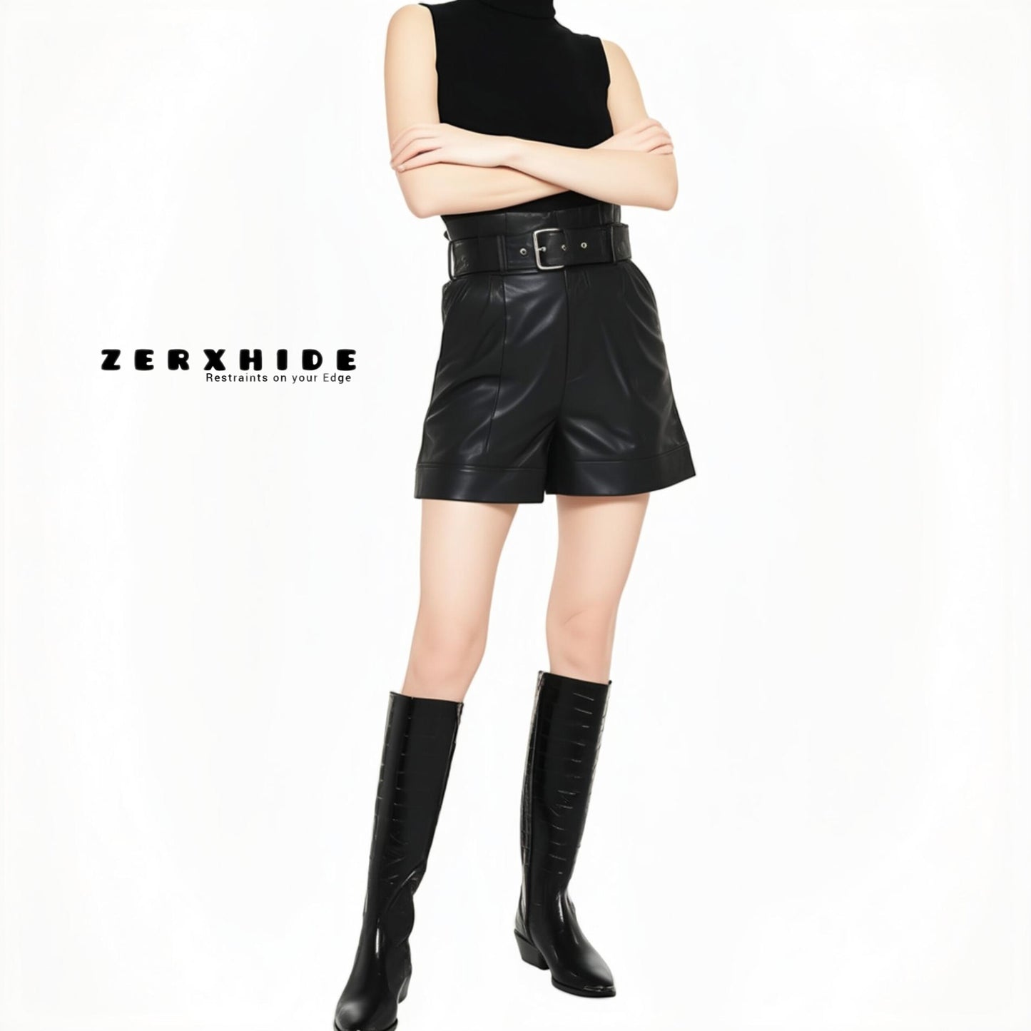ZERXHIDE black leatherette shorts lifestyle — high-waisted belted shorts with cuffed hem styled with boots and turtleneck