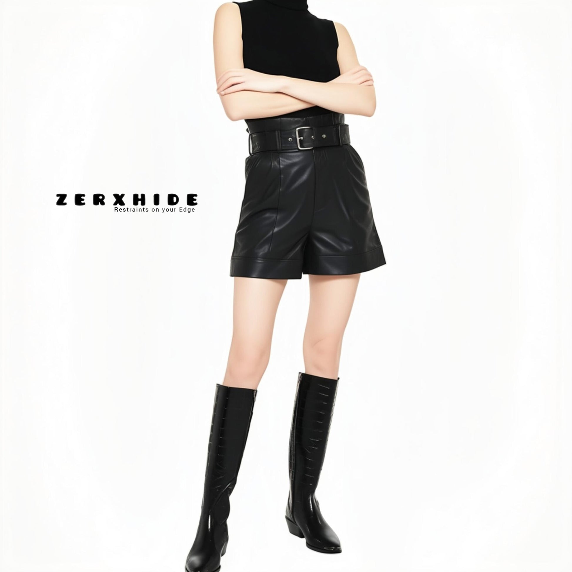 ZERXHIDE black leatherette shorts lifestyle — high-waisted belted shorts with cuffed hem styled with boots and turtleneck