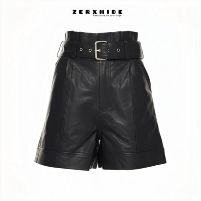ZERXHIDE black leatherette shorts — front view with wide silver buckle belt and cuffed hem, high-waisted